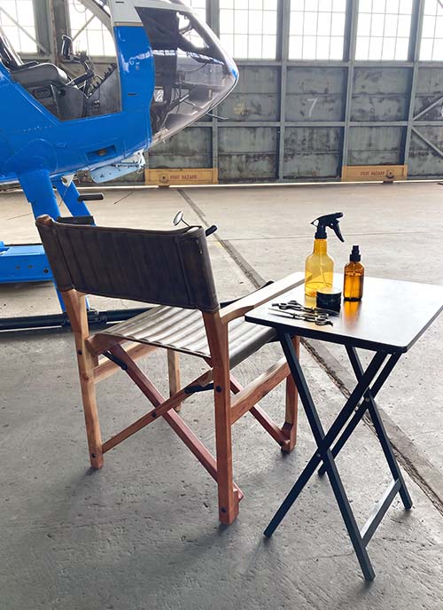 Private-haircut-airport-hangar photo of setting up a private haircut in an airport hangar